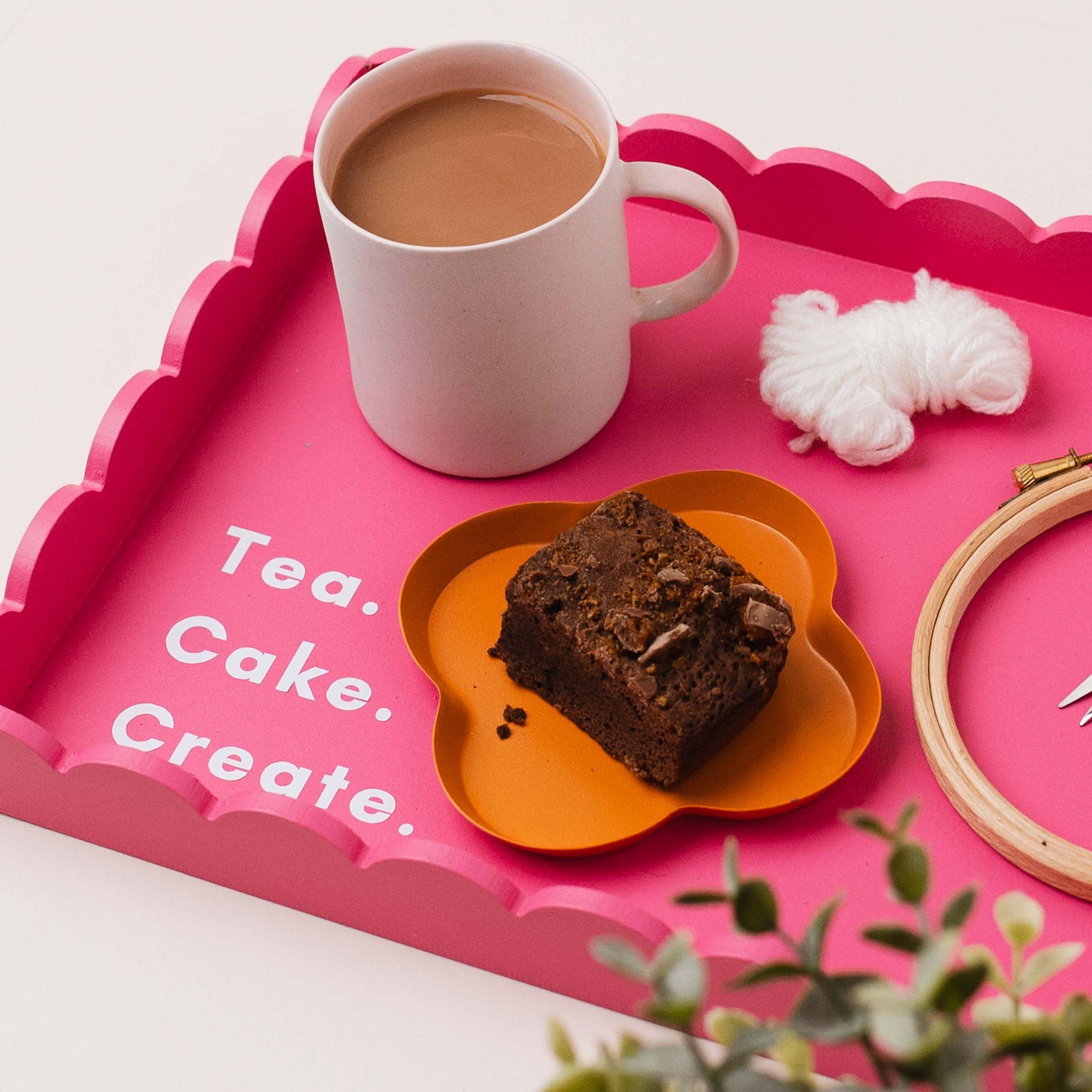 A Teabreak in progress: a warm drink, a small creative project and a candle on an ordinary table.