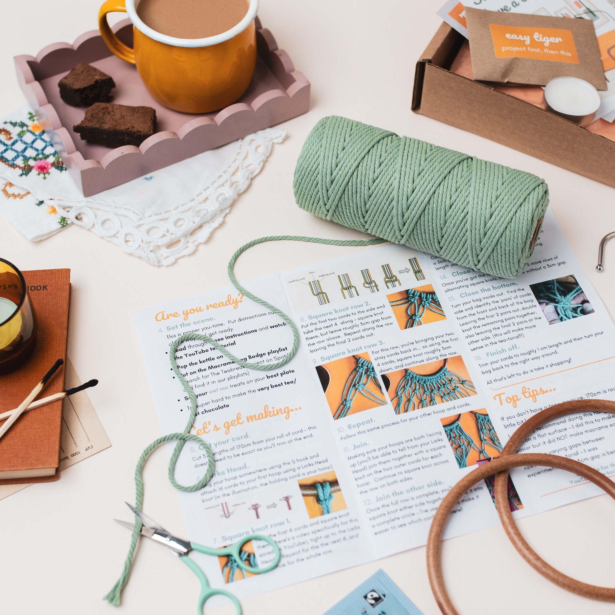 A Teabreak spread out on a table with tea, cake, a tealight and the month's creative project ready to begin