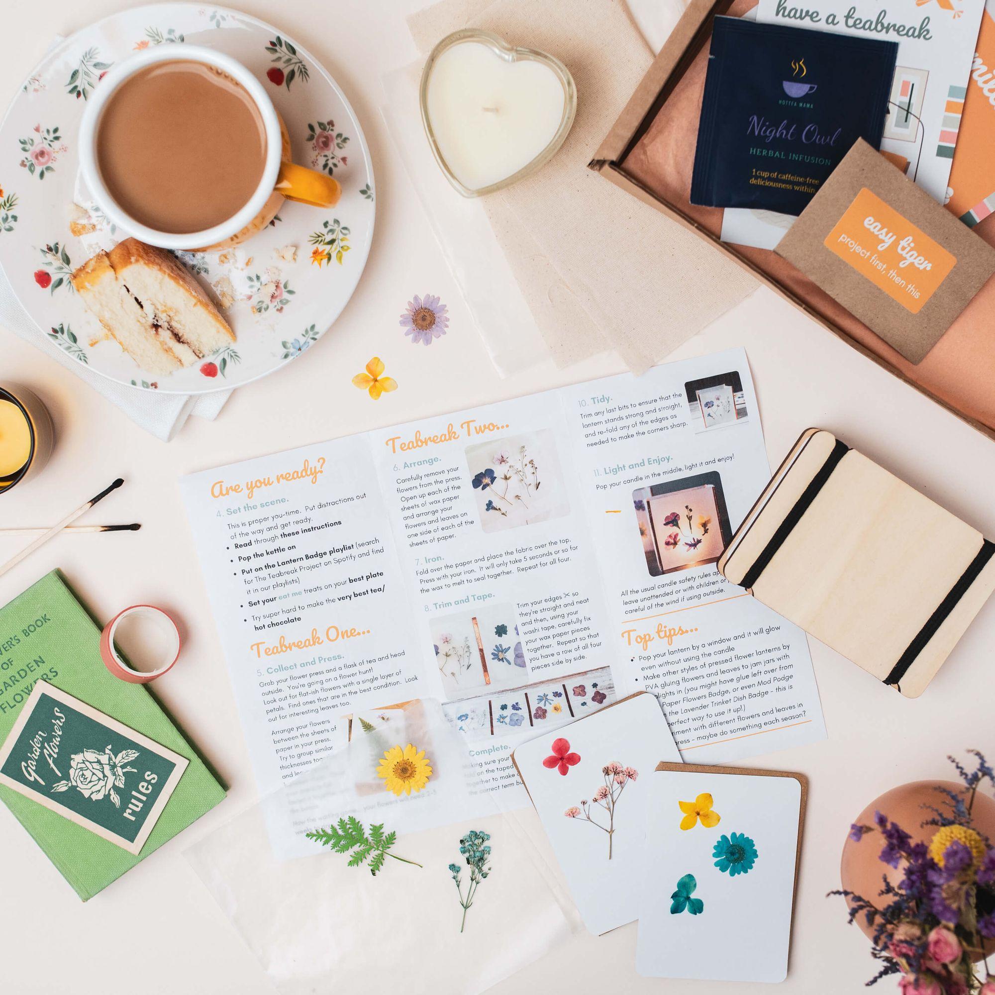 A Teabreak laid out with tea, cake, a tealight and creative project instructions