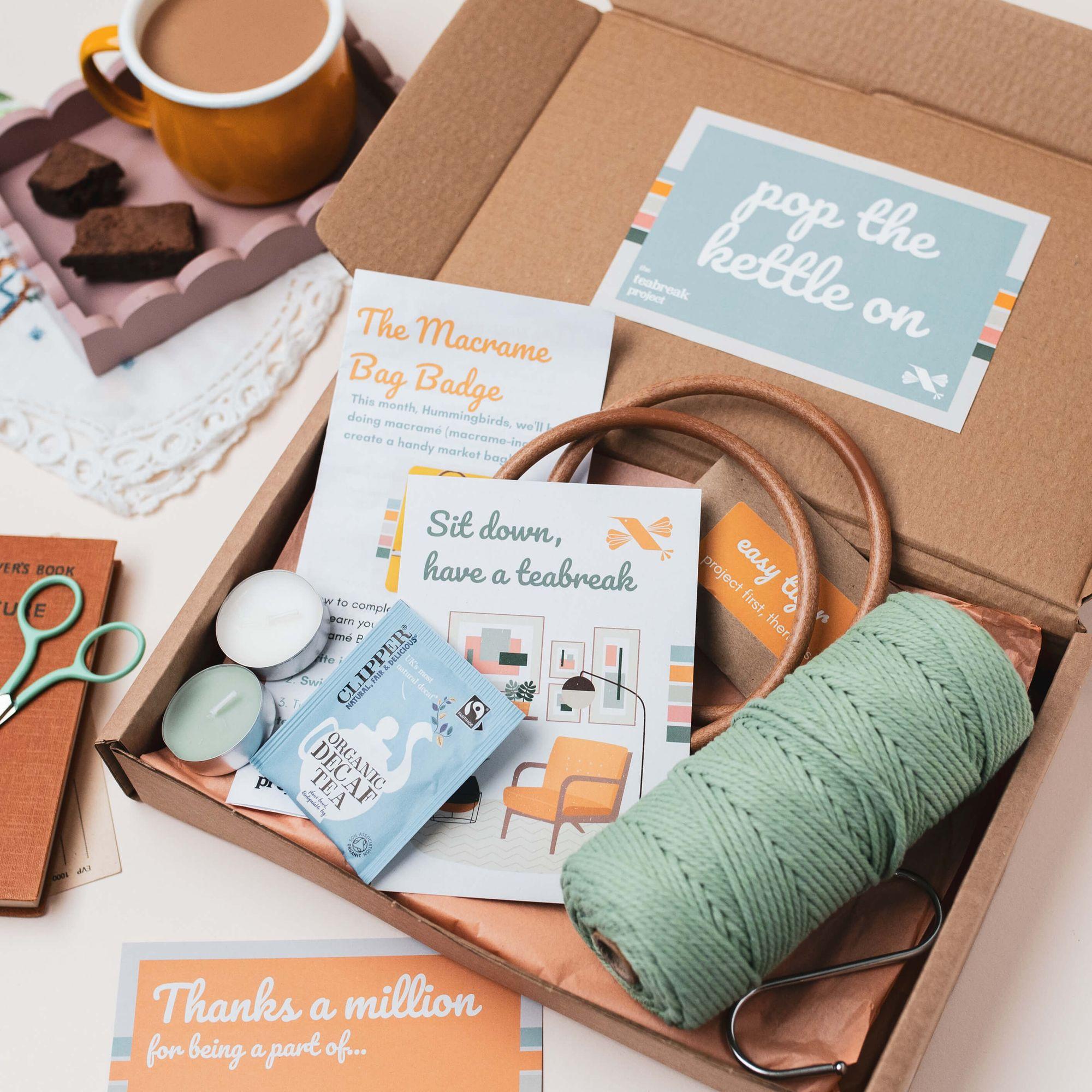 A Teabreak laid out with tea, cake, a tealight and the month's creative project