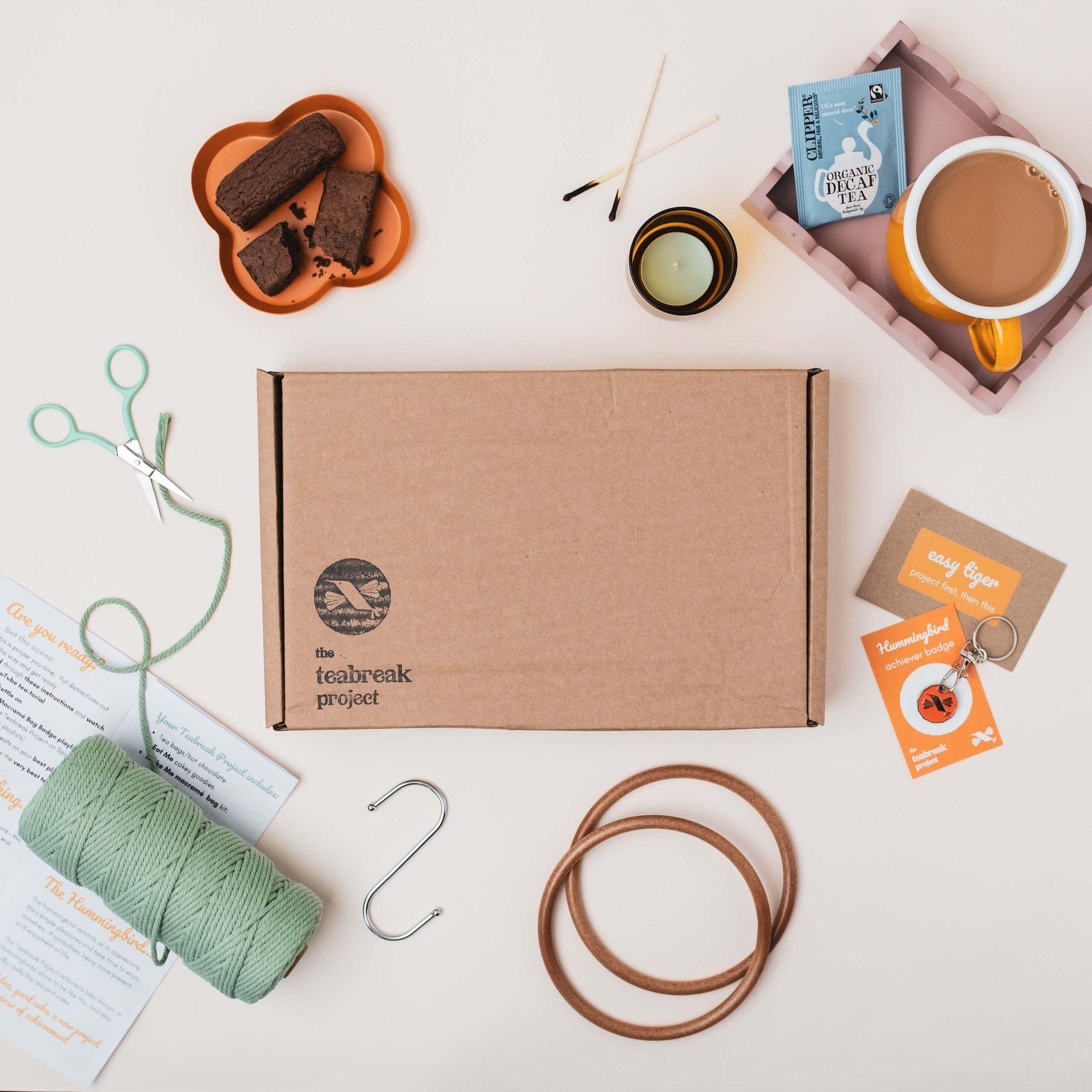 A Teabreak box laid out with a creative project, yarn, a drink and thoughtful extras