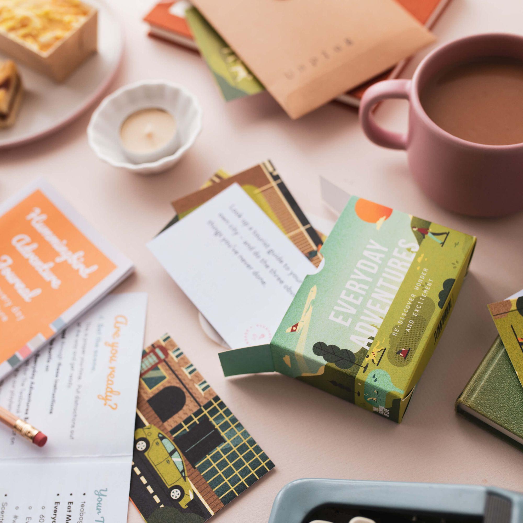 A Teabreak scene with mugs, cake, a candle and colourful creative materials
