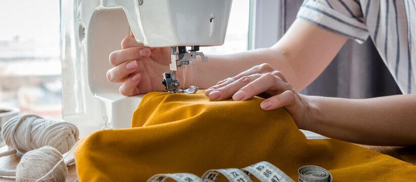 A sewing project in progress, with fabric and thread ready to hand.