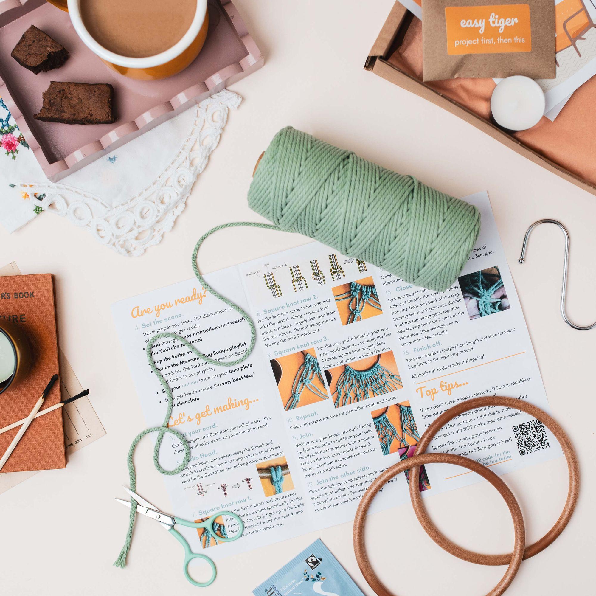 A Teabreak project spread on a kitchen table with tea and cake